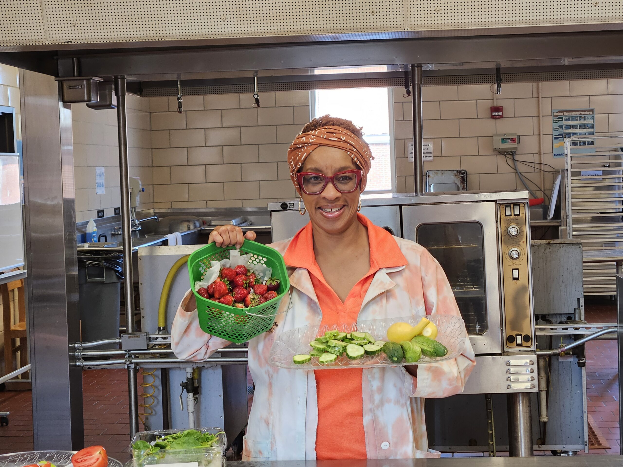 woman holding up food in cooking class